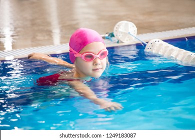 Little  Girl Swimming In Blue  Pool