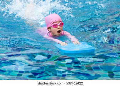 Little Girl Swimming In Pool.