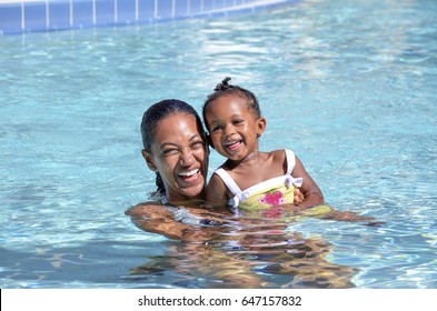 Little girl swims with her mom - Powered by Shutterstock