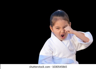 Little Girl In Taekwondo Outfit Acting Fight Isolated On Black Background