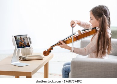 Little Girl Taking Music Lessons Online At Home