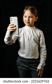 Little Girl Talking On Camera With Different Emotions On Black Background