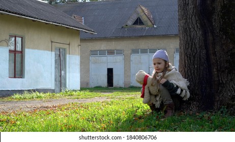 Little Girl With Teddy Bear. Orphan Child. Mistreated Child.