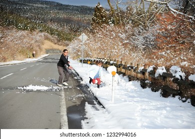 Little Girl And Teenage Boy Playing Snowball Fight. Shizuoka Prefecture, Japan. Winter Of February 2011.