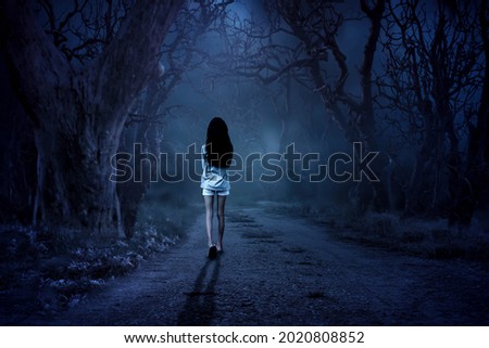 The little girl was terrifyingly wandering through the forest at night.