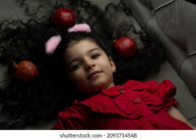 Little Girl With Three Pomegranates Around Of Her Hair. Happy Yalda Iranian Celebration Theme