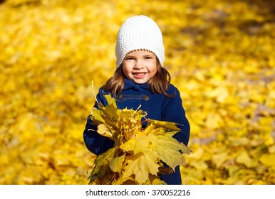 Little Girl Throwing Autumn Leaves