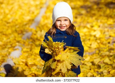 Little Girl Throwing Autumn Leaves