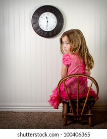 Little Girl In Time Out Or In Trouble Looking, With Clock On The Wall