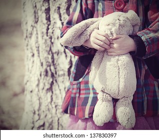 Little Girl Toddler Holding A Stuffed Bunny Toy