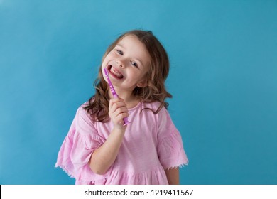 little girl with a toothbrush in dentistry nice