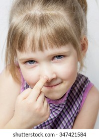 Little Girl Touching Her Nose - Closeup Portrait