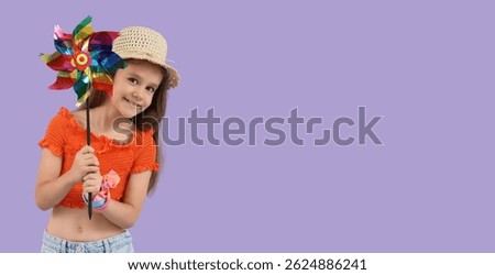 Little girl with toy windmill on lilac background with space for text