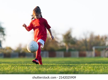 Little  girl is training in indoor soccer field - Powered by Shutterstock