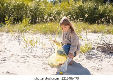  Little Girl With Trash Bag Cleaning Up The Beach. Child Collects Plastic, Garbage On The Beach By The Sea.