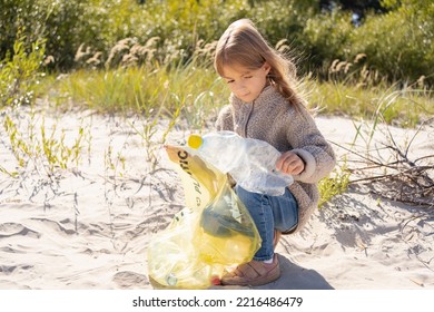  Little Girl With Trash Bag Cleaning Up The Beach. Child Collects Plastic, Garbage On The Beach By The Sea.