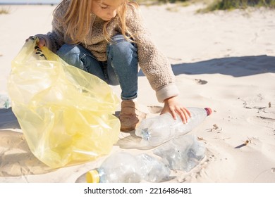  Little Girl With Trash Bag Cleaning Up The Beach. Child Collects Plastic, Garbage On The Beach By The Sea.