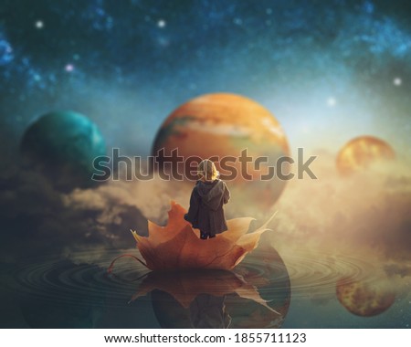 Little girl travelling through dream world, floating on a big fallen leaf; imaginationfantasy background; Elements of this image furnished by NASA