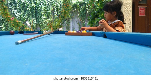 A Little Girl Is Trying To Arrange And Play A Billiard Ball In Colomadu, Karanganyar Regency, Central Java, Indonesia. October 2019, 11:03:24