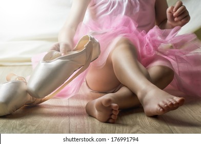 Little Girl Trying On Ballet Shoes