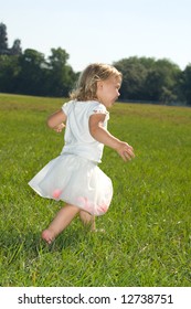 Little Girl In Tutu Running In Field