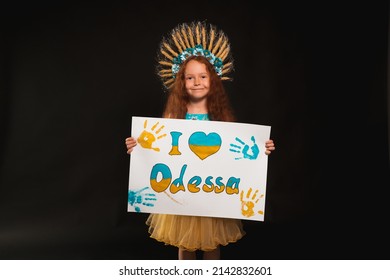 A Little Girl From Ukraine Stands In The Dark And Shakes A Poster On What Is Written In Colors I Love Odessa
