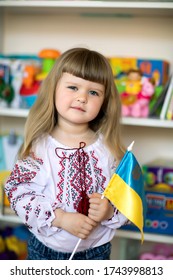 little girl in Ukrainian national dress embroidered with a flag - Shutterstock ID 1743998813