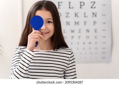 Little girl undergoing eye test in clinic - Powered by Shutterstock