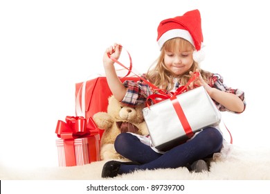 Little Girl Unwrapping A Christmas Present