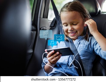 Little Girl Using A Phone In A Car