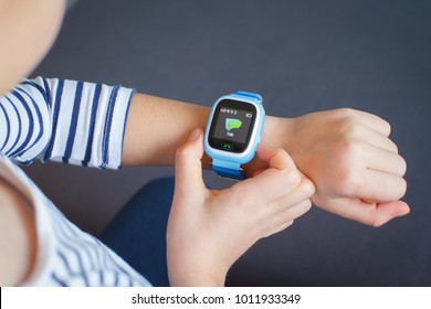 Little Girl Is Using Smartwatch Phone.