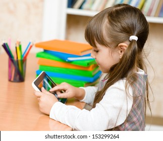 little girl using tablet computer - Powered by Shutterstock