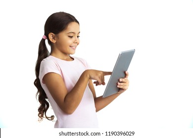 The Little Girl Using The Tablet On The White Wall Background