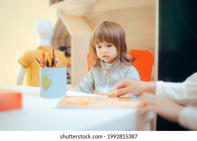 Little Girl Waiting In The Kids Play Corner While Mom Shops
Shop Assistant Keeping A Child Entertained For Better Shopping Experience
