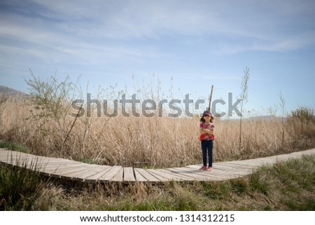 Similar – Image, Stock Photo Little girl climbing to a wooden observation tower in a wetland