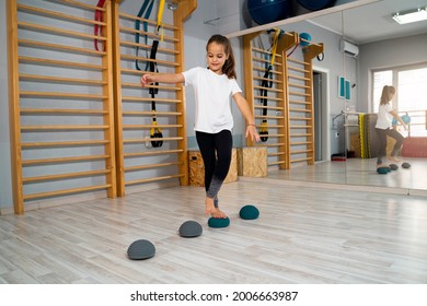 Little Girl Walking Over Rubber Balls With Spikes, For Flat Feet Problems 