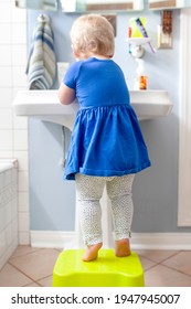 Little girl washing her hands in the sink health photo