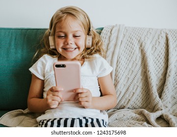 Little Girl Watching Cartoons On Her Phone