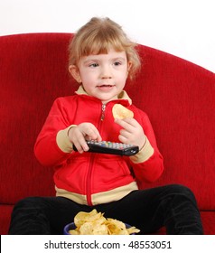 Little Girl Watching Tv And Eating Chips