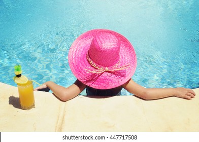 Little girl in watter pool in the summer day