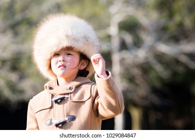 Little Girl Wearing Too Big A Fur Hat