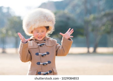 Little Girl Wearing Too Big A Fur Hat