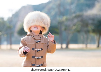 Little Girl Wearing Too Big A Fur Hat