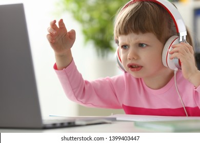 Little girl wearing headphones using computer aggressive articulating portrait