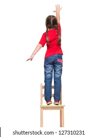 little girl wearing red t-shirt and reaching out something up high on white background - Shutterstock ID 127310231