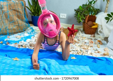 Little girl wearing snorkeling mask imitates swimming in fictional sea or ocean near beach at home quarantine. Coronavirus home summer vacation activity, funny, happy, crazy.