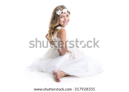 A Little girl wearing white dress on studio
