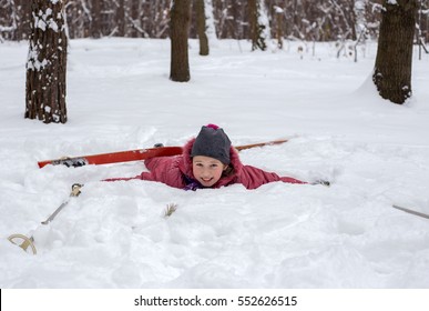 Little Girl In The Winter In The Woods Fallen During Skiing. Skiing Accident.