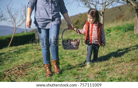 Similar – Image, Stock Photo Little girl and woman carrying basket with apples