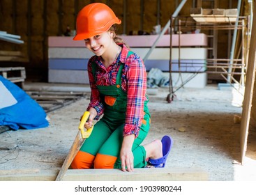 Little Girl Working With Wood. Kid Sawing A Plank In Carpentry. Working With Wood In A Garage. Happy Childhood. Hardworking Child Sawing With Hand Wood Saw. Teenage Girl With Hand-saw.